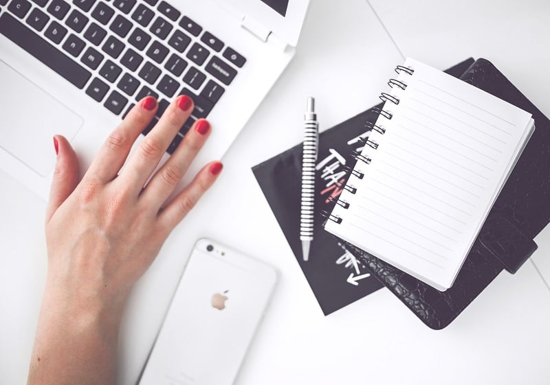 Woman hand smartphone desk